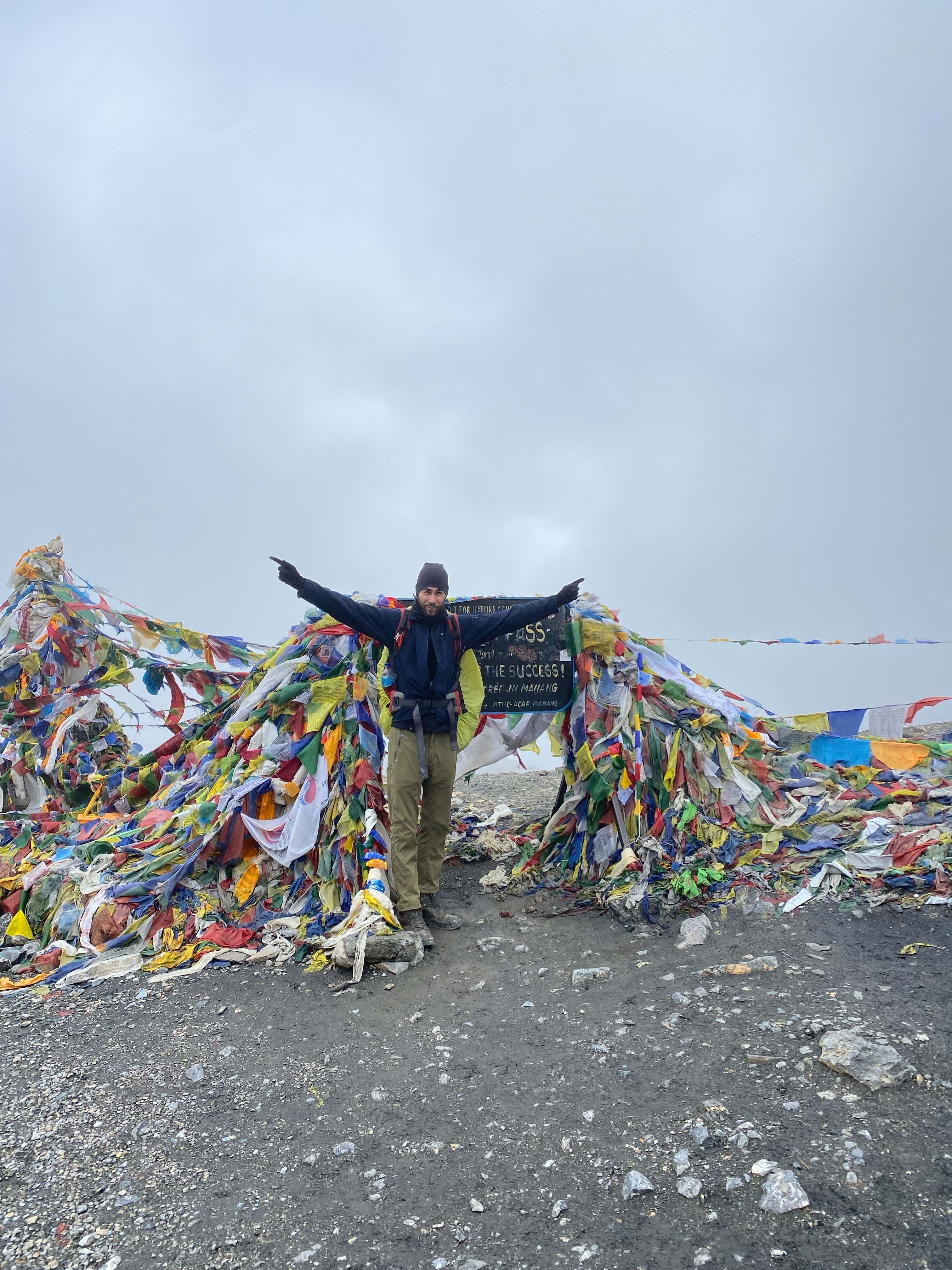 Tourist Trekker of Trek 8586 posing in front of signage board in Tilicho Trek through Annapurna, crossing Thorangla Pass on Trek 8586 journey