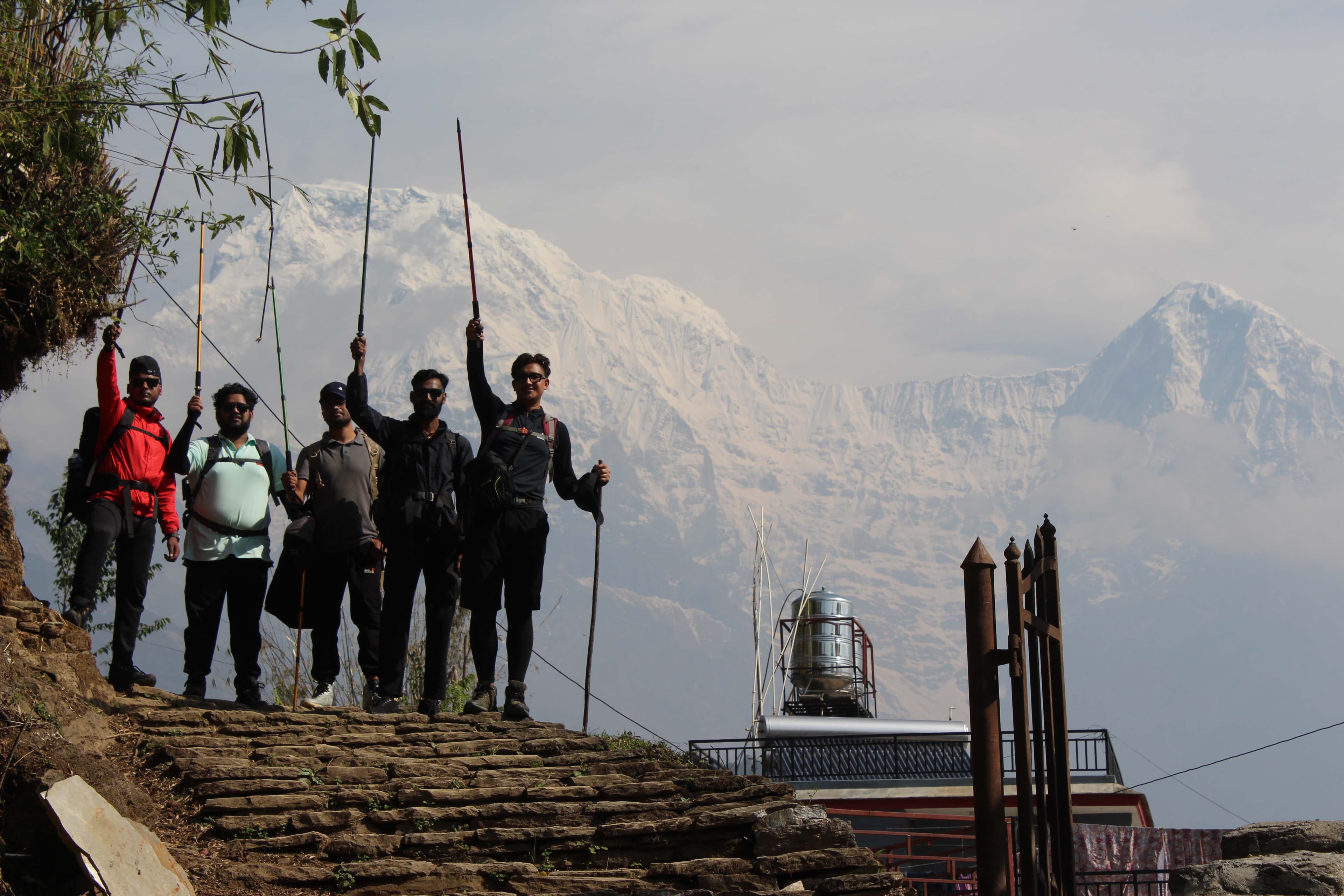 Trekkers of Trek 8586 raising their trekking pole celebrating successfully completion of Annapurna Trek in Annapurna Region