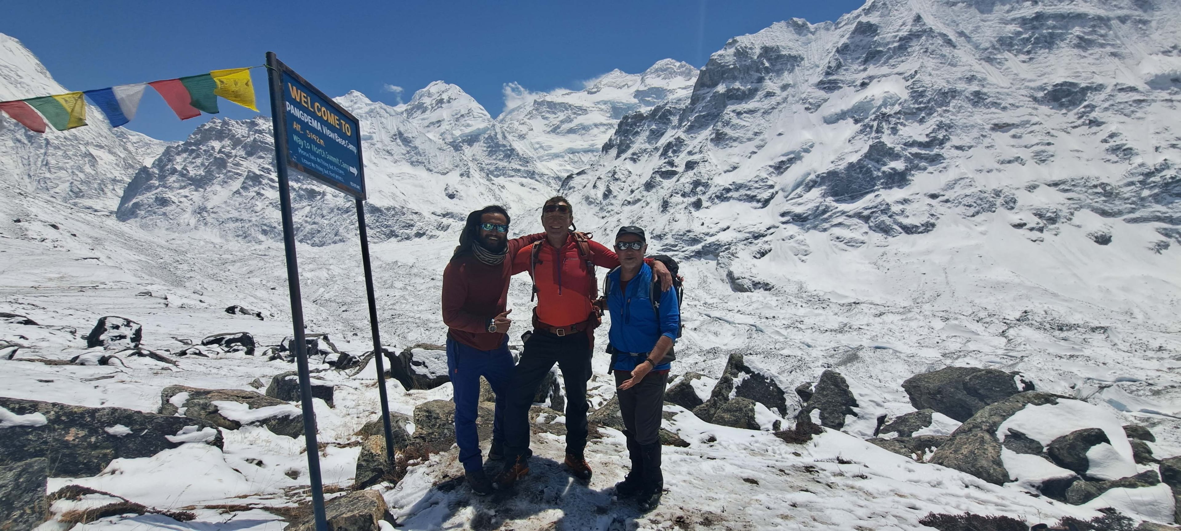 Manoj Basnet with guests of Trek 8586 posing on Kanchenjunga Base Camp during their trek to Kanchenjunga Trek