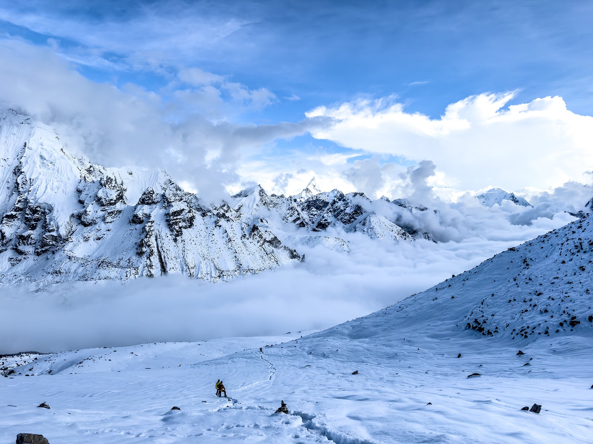 Snow-covered landscape in the Everest Region, with pristine white snow blanketing the rugged terrain, creating a breathtaking scene for trekkers in the Himalayas.